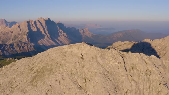 Aerial view above individual cross on South Tyrol Plose Peitlerkofel Dolomites mountain peak overloo