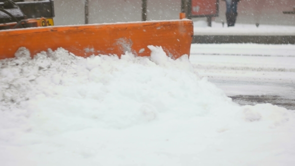 Front Shot Of Plower Cleaning Up Snow alt
