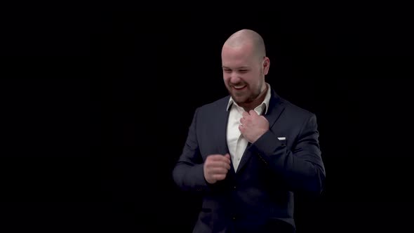 Bald Bearded Handsome Businessman, Man in Blue Jacket and White Shirt Looks Around, Rejoices in