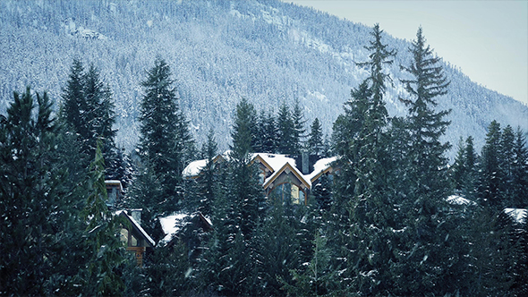 Snow Falling On Houses In The Mountains