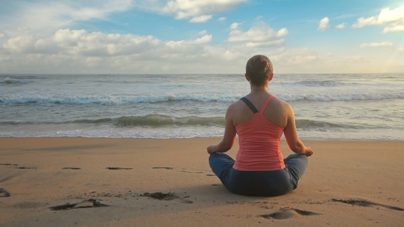 Woman Meditating At Beach