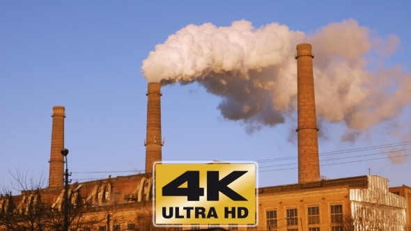 Factory Plant Smoke Stack Over Blue Sky Background