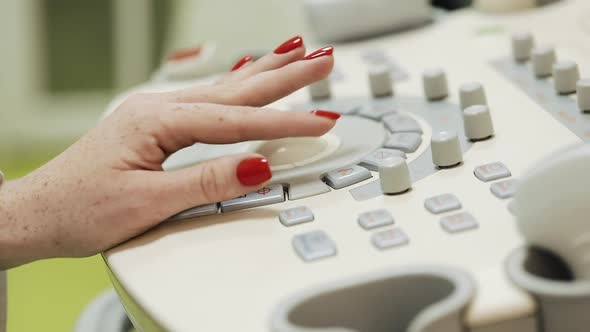Ultrasound Console Is Being Manipulated By Doctor's Hand