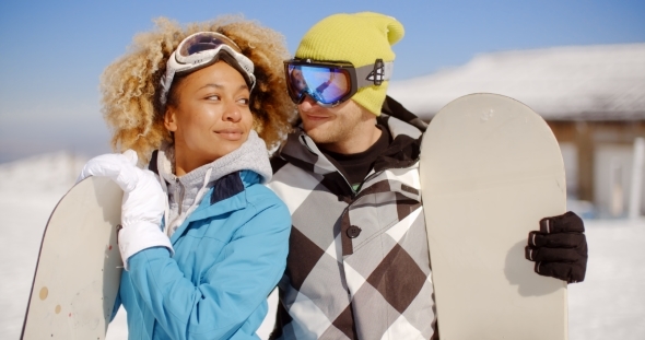 Affectionate Young Couple Posing With Snowboards