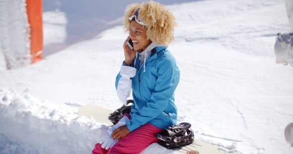 Laughing Woman Chatting On Her Mobile In Snow