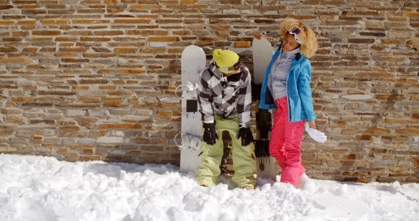 Snowboarder With Happy Friend In Front Of Wall