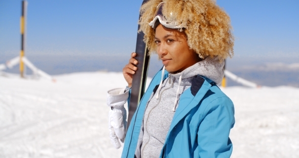 Thoughtful Young Woman Standing Holding Her Skis