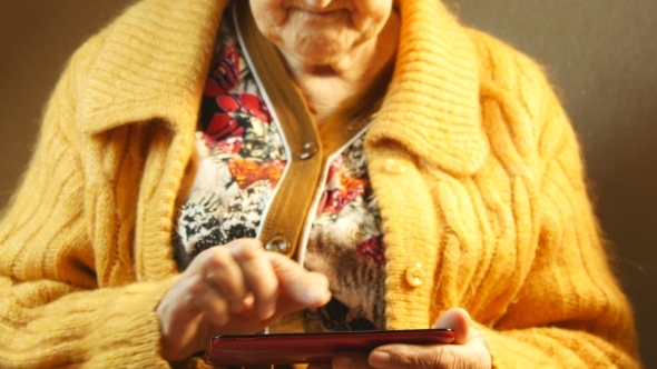 Old Woman And Electronic Tablet  alt