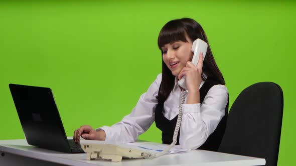 Woman Flirting on the Phone From the Workplace. Green Screen