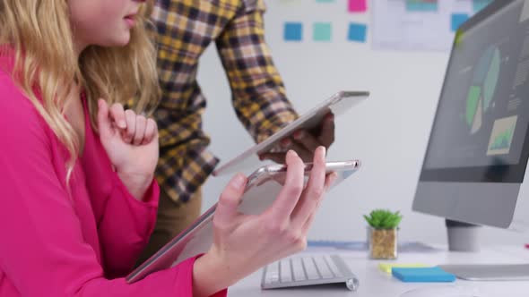 Man and woman using touch pad at the office