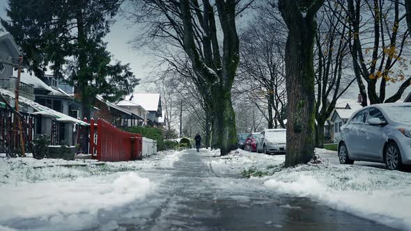 Person Walks On Sidewalk In The Snow