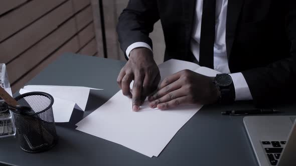 africanAmerican Business Man Makes Paper Airplane