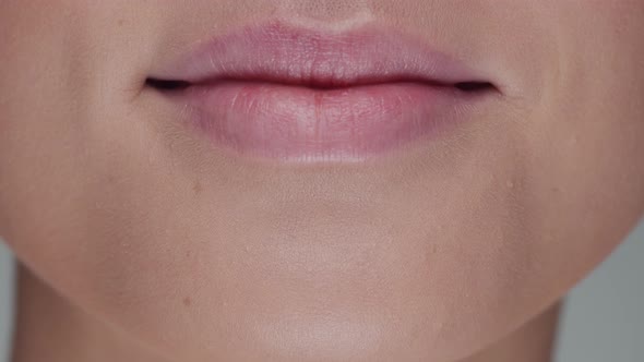 Close-up portrait of young, beautiful and natural woman opening her mouth and smiling.