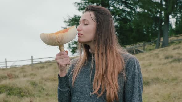 Closeup Young Woman Sniffs Huge Toxic Fly Agaric Amanita on Autumn Day
