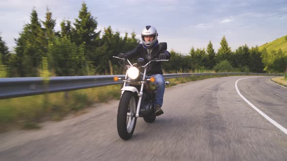 Biker on the Forest Road Riding