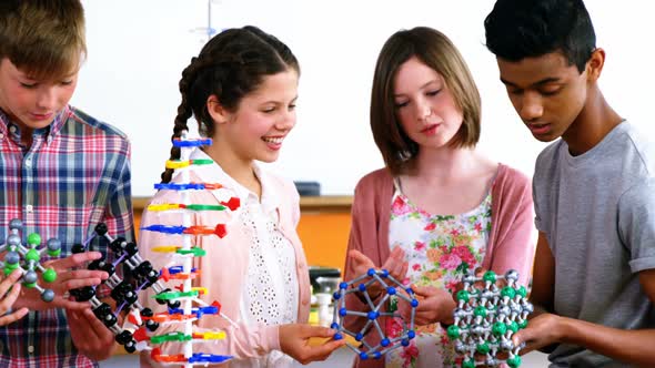 School students experimenting molecule model in laboratory