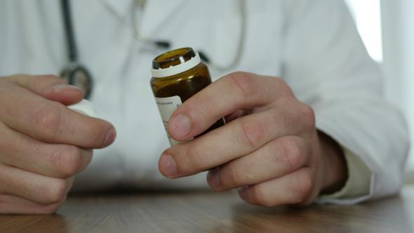 Doctor With Pills In Hands alt