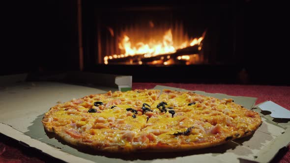 A Tasty Pizza is Taken Piece By Piece a Group of People Dinner By the Fireplace