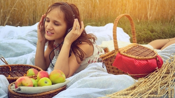 Young Pretty Woman On Picnic Listening To Music In Wheat Field In 