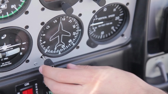 Instrument Panel In The Plane And The Pilot's Hand