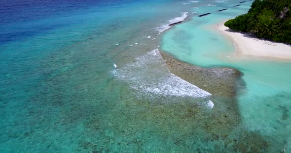 Daytime birds eye abstract shot of a summer white paradise sand beach and blue ocean background in c