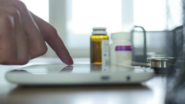 Doctor Fingers Using Tablet In Hospital