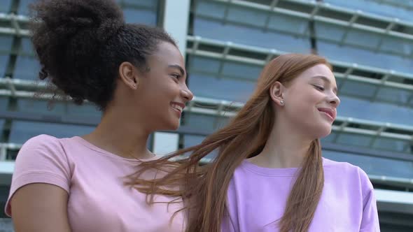 Shy Multiethnic Teenage Girls Smiling and Looking at Admirers, First Sympathy