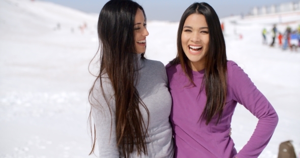 Laughing Vivacious Young Women At a Ski Resort