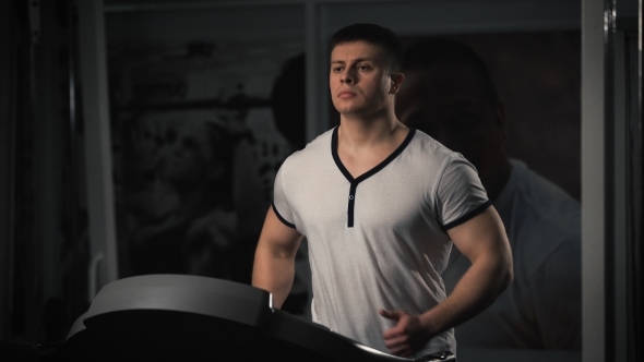 Man On Running Machine In Gym