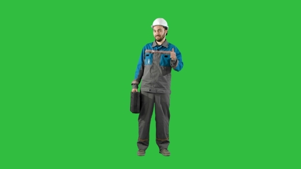 Construction Engineer With Tablet And Drawing In Hands, Man Walks At Camera On a Green Screen