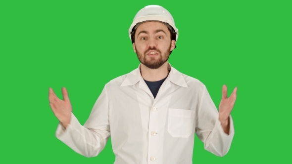 Smiling Male Architect With Talking On Camera On a Green Screen, Chroma Key.