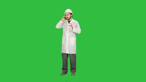 Engineer Talking Phone On Construction Site On a Green Screen
