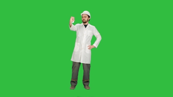 Engineer Or Architect Taking a Selfie Showing Gesture On a Green Screen, Chroma Key.