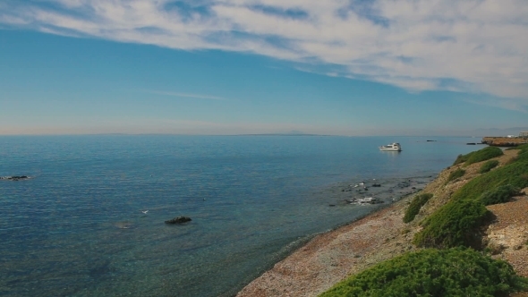 White Sail Yacht Far On The Horizon Over Sea. 
