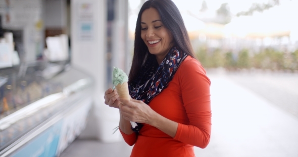 Attractive Young Woman Eating An Ice Cream Cone