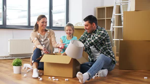 Happy Family Playing with Foam Peanuts at New Home