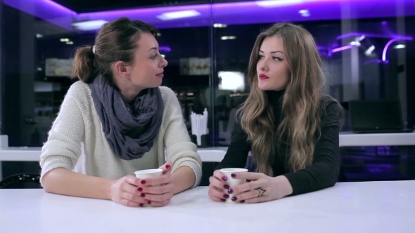 Two Beautiful Girls Talking In Cafe alt