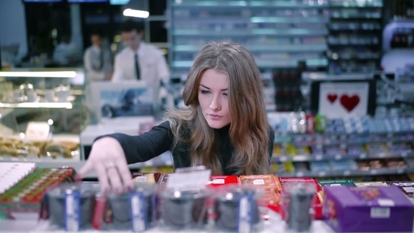 Beautiful Girl Selects Products In Supermarket alt
