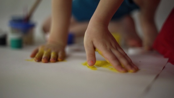 Children Draw on Paper with Palms and Gouache