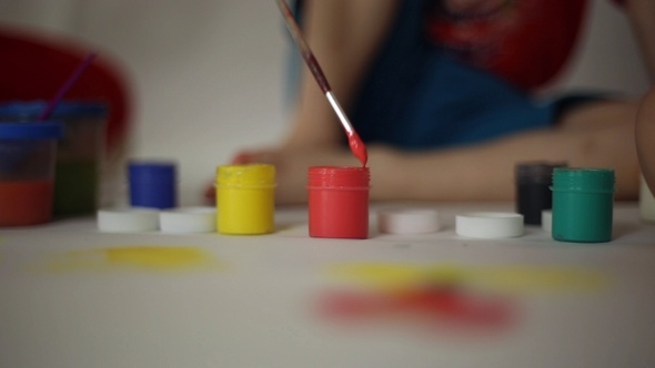 Children Draw on Paper with Brushes and Gouache