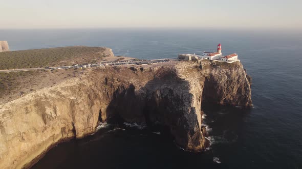 Lighthouse of Cape of Sao Vicente, Sages, Algarve, Portugal. Magnificent cliffs. Orbiting shot