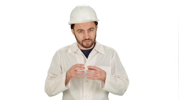 Construction Worker On Building Site Talking To Camera On White Background.