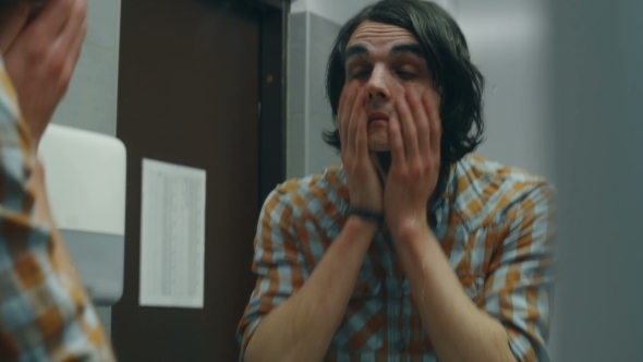 Young Man Washes His Hands And Face