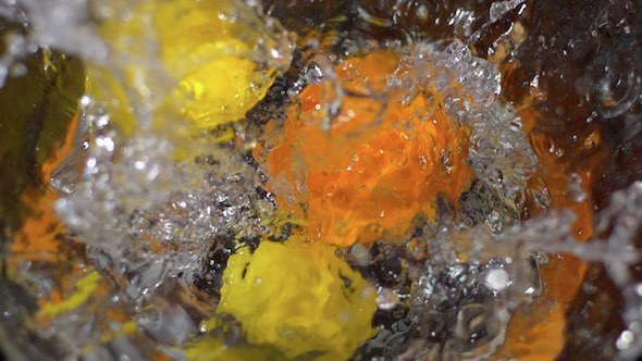 Lemons And Orange Falling Into Water