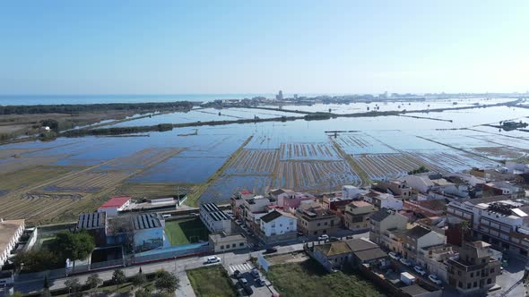 Aerial Drone Footage of the Agricultural Fields Village Submerged in Water with Blue Sky in Albufera