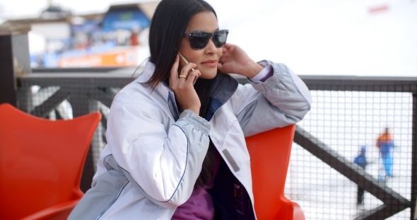 Young Woman Relaxing At An Alpine Ski Resort alt