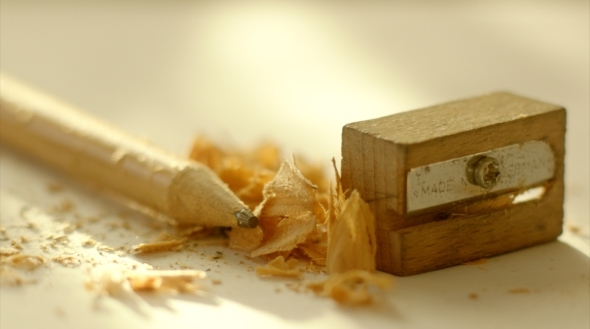 Pencil, Sharpener And Shavings On White Paper