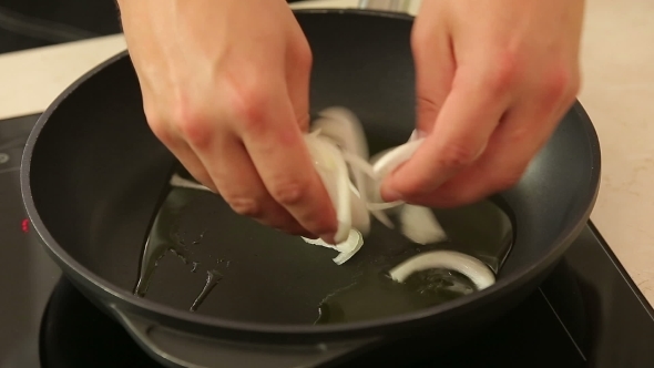 Chef Drops Chopped Onions Into Wok