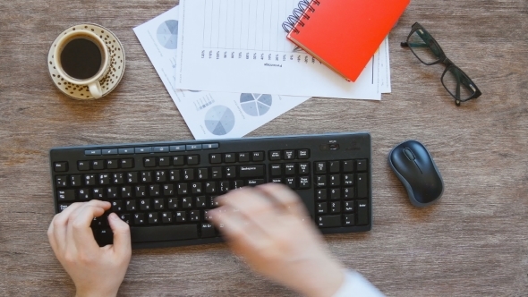 View From Above Of Man's Hands Typing.