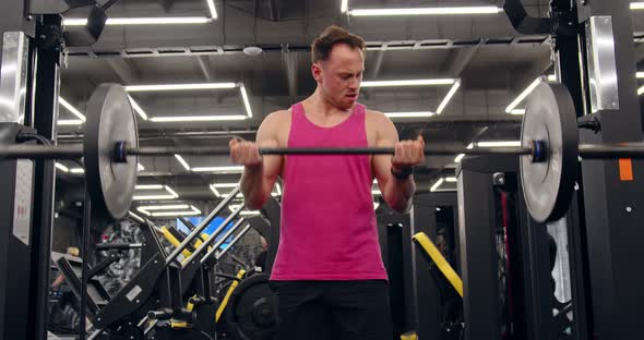 Bodybuilder Doing An Exercise With A Barbell In The Gym